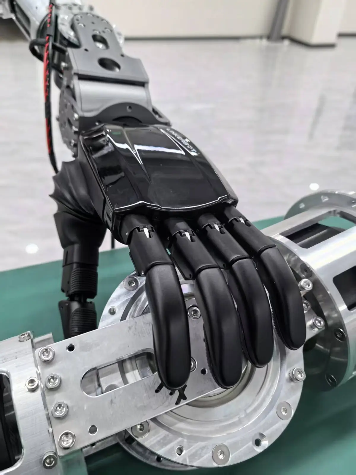 Robotic hand gripping a circular metal mechanical component